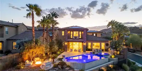 Image 4: An inviting backyard oasis showcases a sparkling s