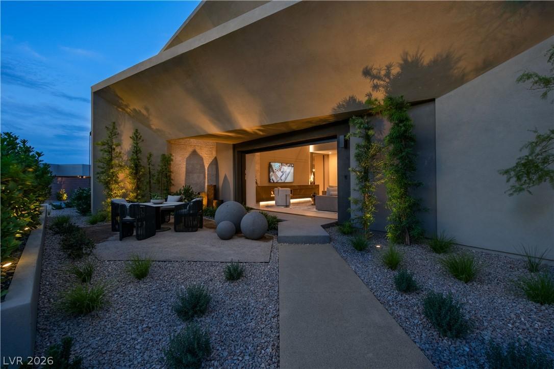 Image 3: An inviting outdoor living space features a covere