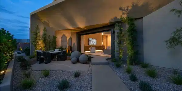 Image 3: An inviting outdoor living space features a covere