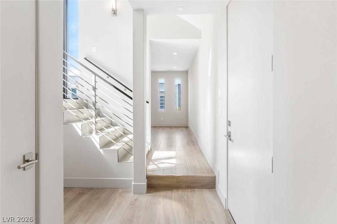 Image 2: A sleek, contemporary entryway features an open st