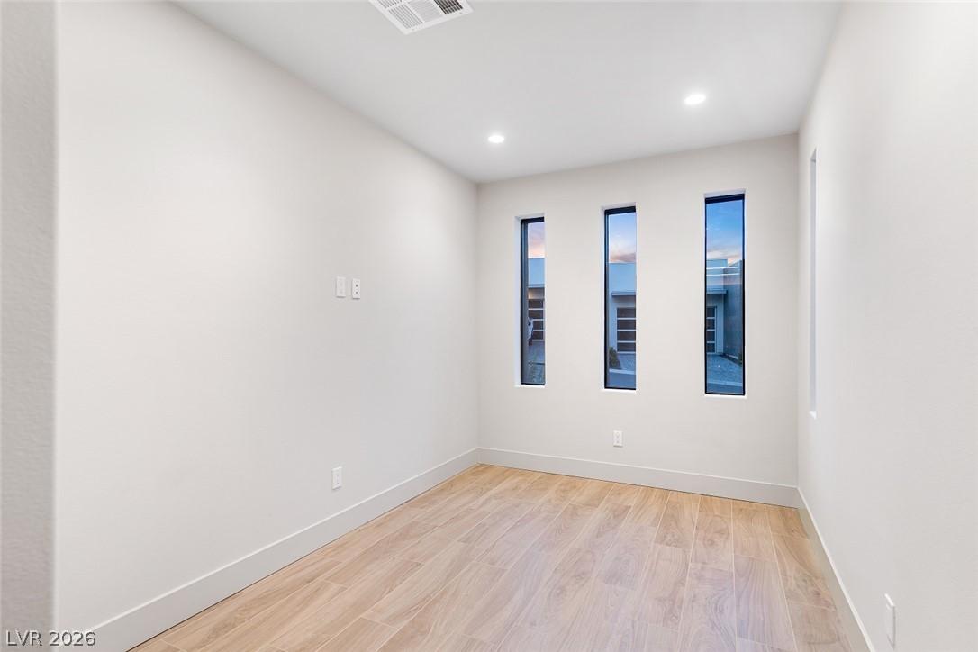 Image 3: Recessed lighting illuminates this bright room wit