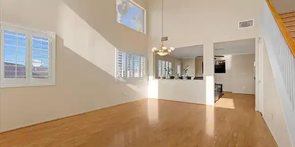 Image 4: Sunlight streams across gleaming wood floors under