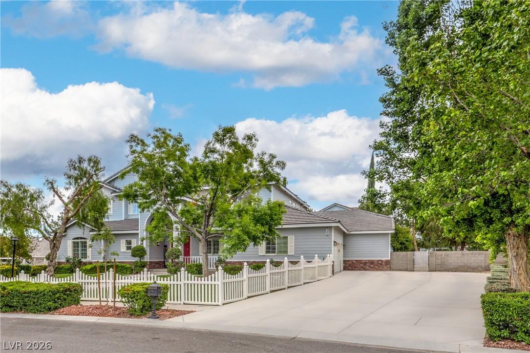 Image 3: This charming home offers a spacious driveway and
