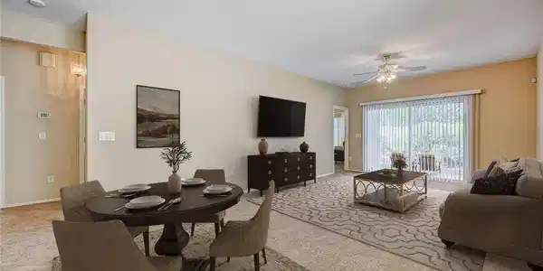 Image 2: A spacious living area with warm walls, plush carp