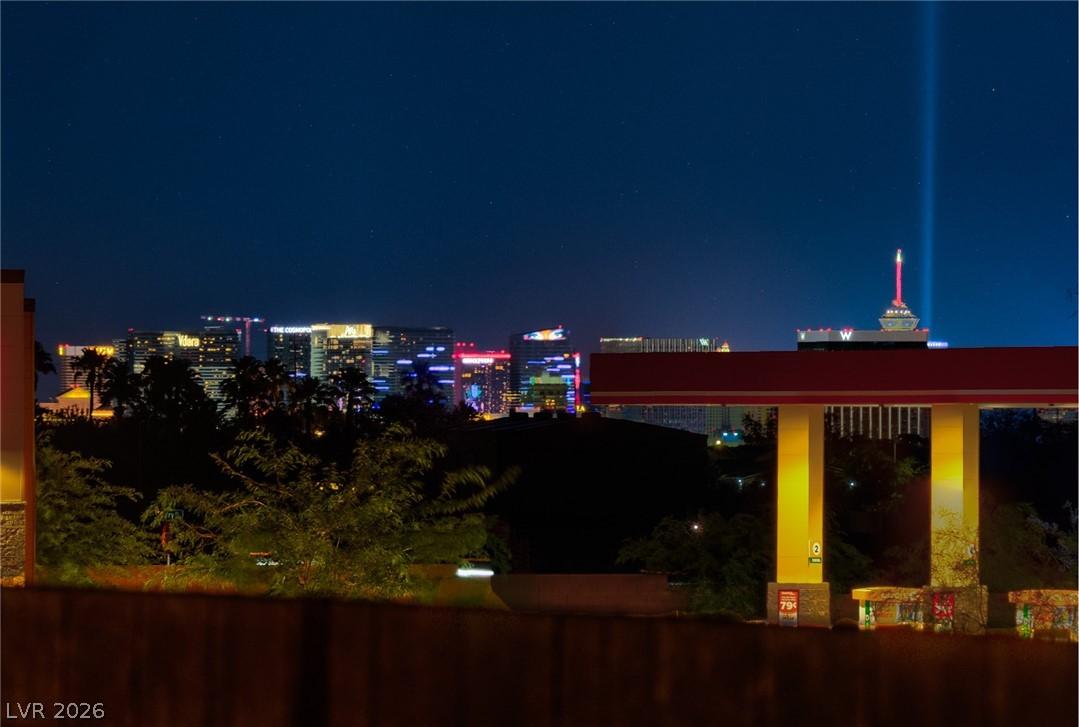 Image 4: Vibrant city lights illuminate the night sky, crea