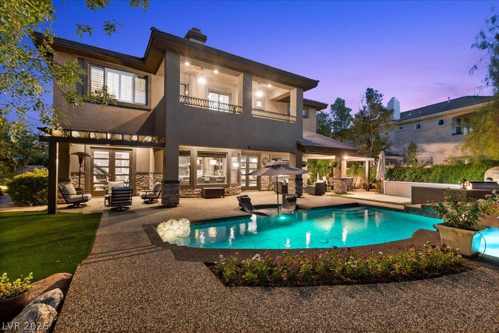 Image 2: Relaxing backyard oasis centered around a glisteni