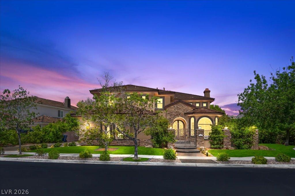 Image 4: Elegant home showcasing detailed stonework and lus