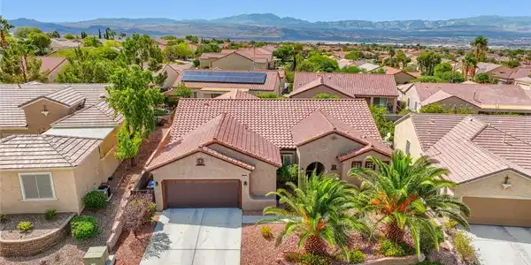 Image 2: A classic tile roof and concrete driveway define t