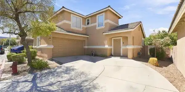 Image 2: A spacious concrete driveway leads to the attached