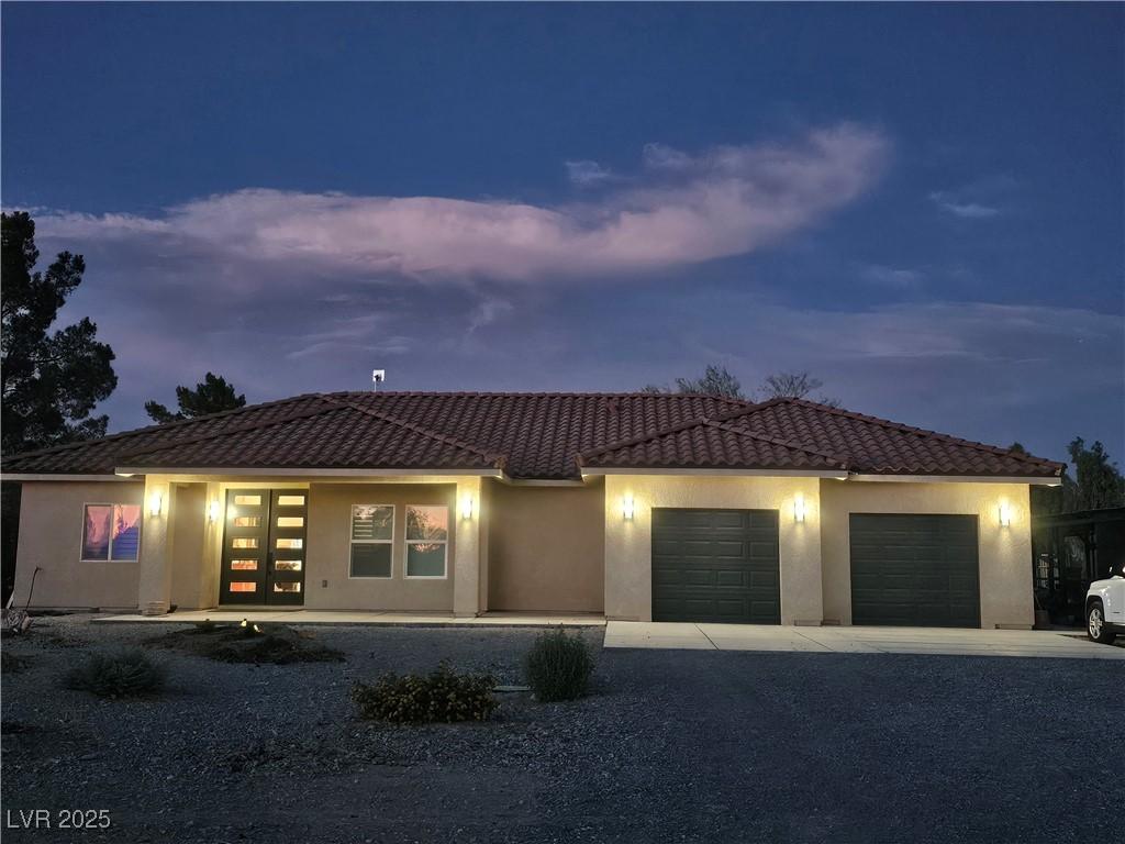 Image 1: View of front of house with driveway, a garage, a