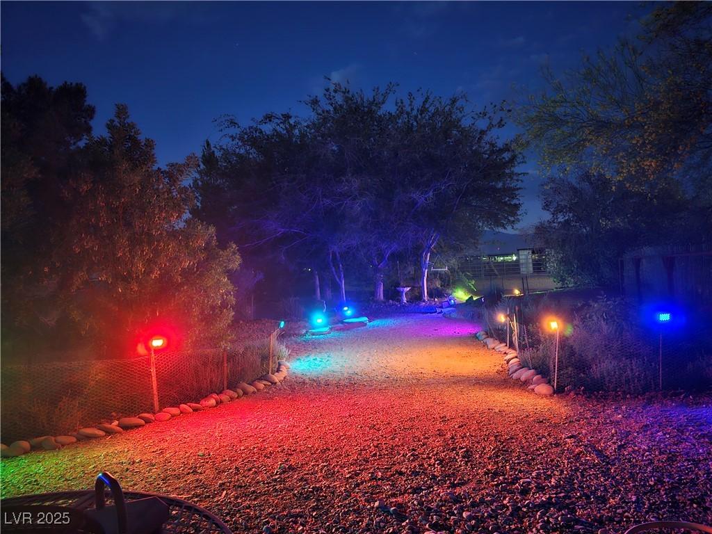 Image 3: Yard at night with a pool