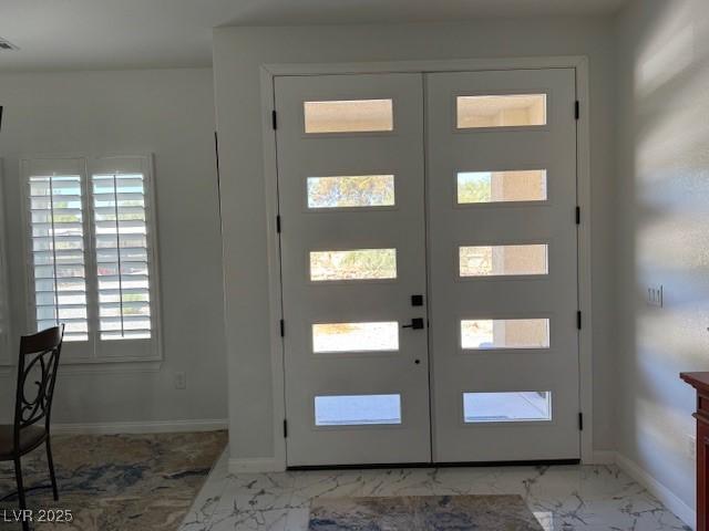 Image 4: Foyer with light marble finish floors and french d
