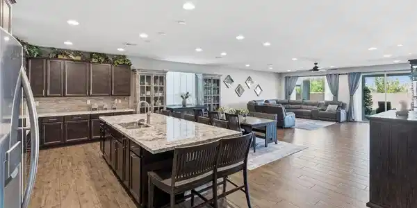 Image 4: An open concept living area seamlessly connects a