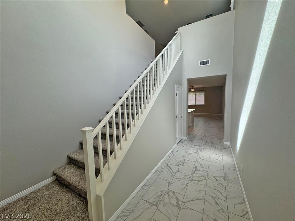 Image 2: A spacious entry hallway features high ceilings an