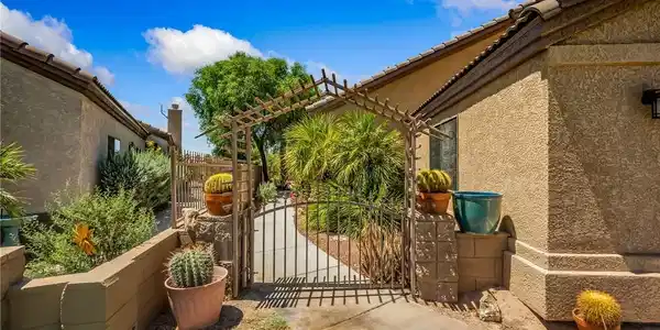 Image 2: Enter through the charming gated arbor into a dese