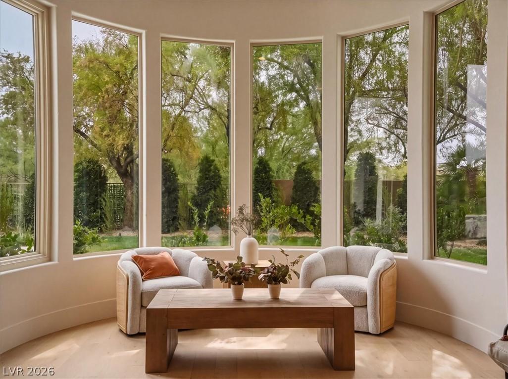 Image 3: Natural light floods this inviting sitting room, o