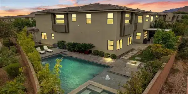 Image 2: An inviting backyard oasis centers around a pristi