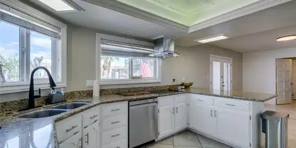 Image 2: This expansive property features a tile roof, pave