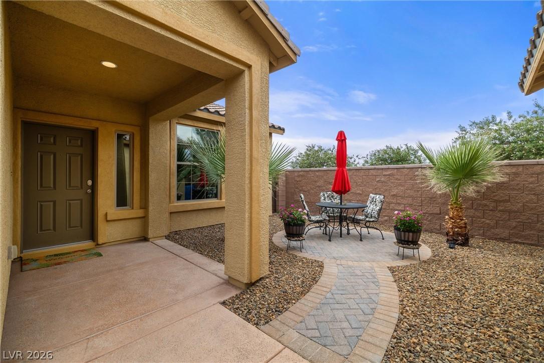 Image 4: This charming entrance features a private patio pe