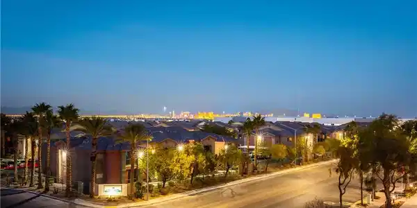 Image 4: Distant city lights shimmer on the horizon beyond