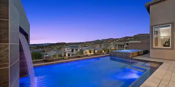 Image 2: An inviting pool with a cascading water feature of