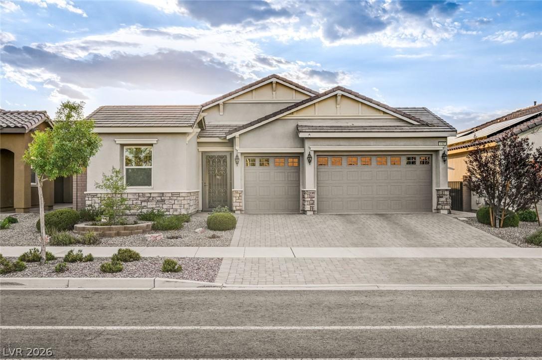 Image 1: A welcoming facade showcases a paver driveway, att