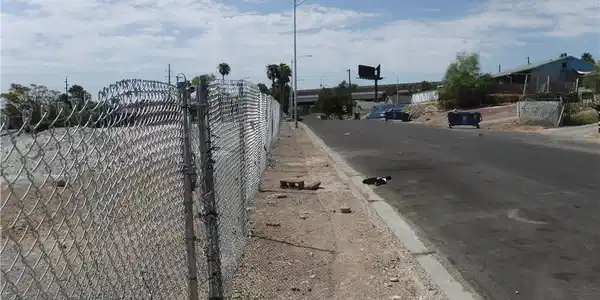 Image 2: View of asphalt road featuring curbs