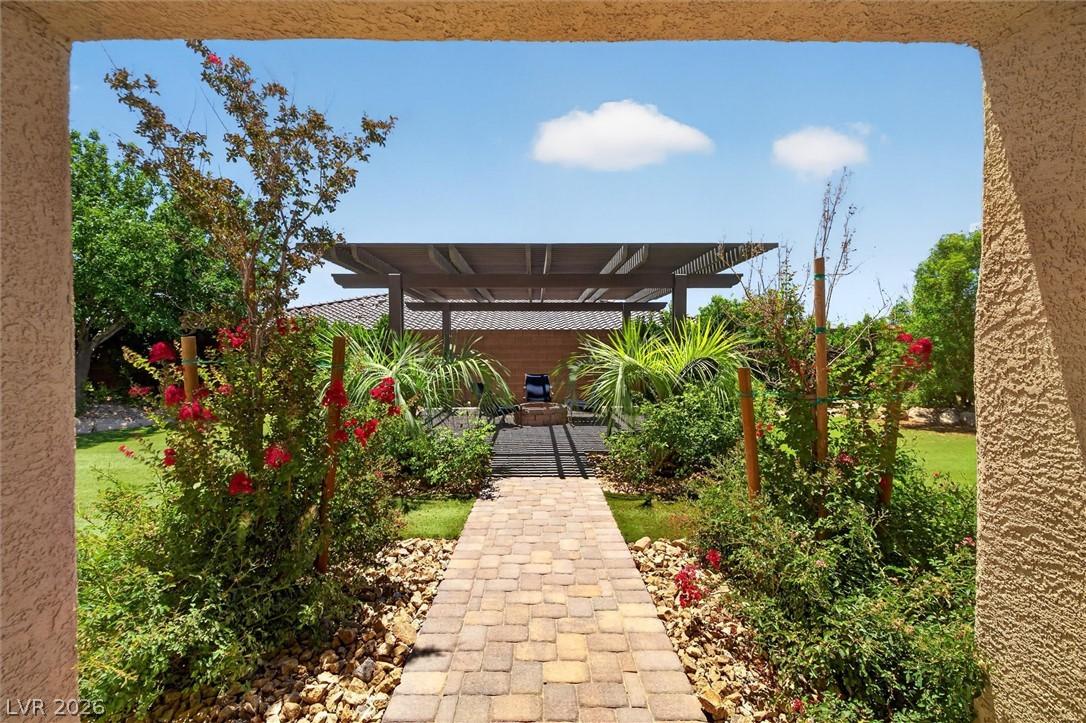 Image 1: A paver stone pathway leads to a shaded pergola am