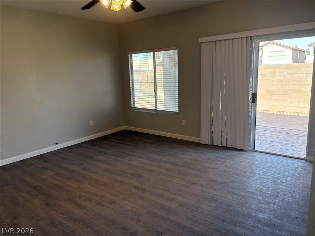 Image 4: Wood flooring and a ceiling fan define this versat