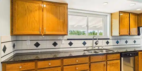 Image 4: A well-equipped kitchen features ample cabinetry,