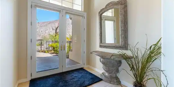 Image 3: Double glass doors framed by a transom window open