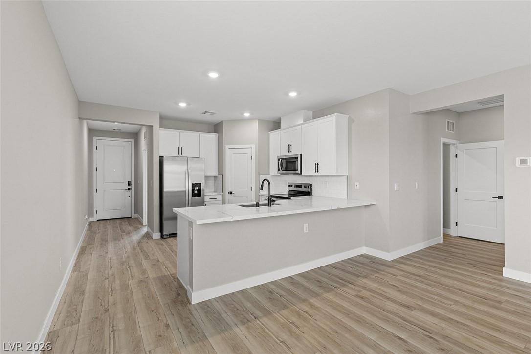 Image 2: A streamlined open-concept kitchen and living area