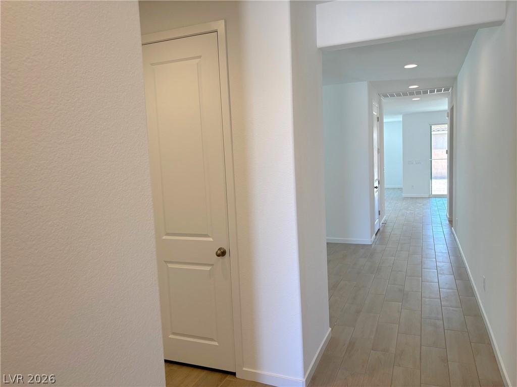 Image 3: Corridor with wood tiled floors and recessed light