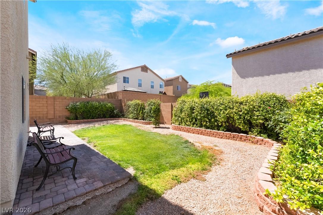 Image 2: A charming private yard, featuring a paved patio a