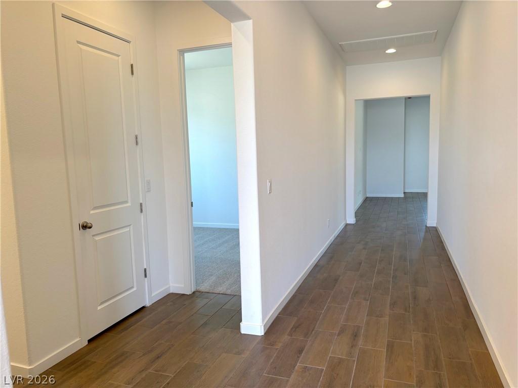 Image 3: Corridor featuring wood tiled floors and recessed