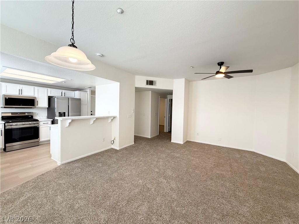 Image 4: This inviting living area seamlessly connects to t