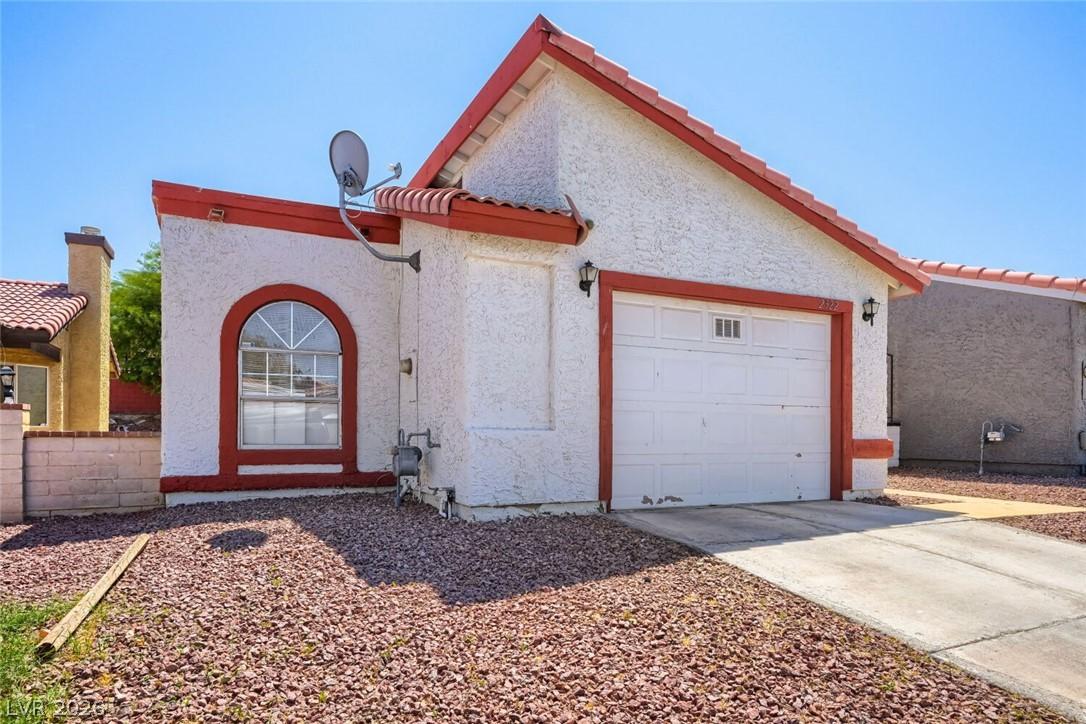 Image 2: Facade with red accents welcomes you to this deser
