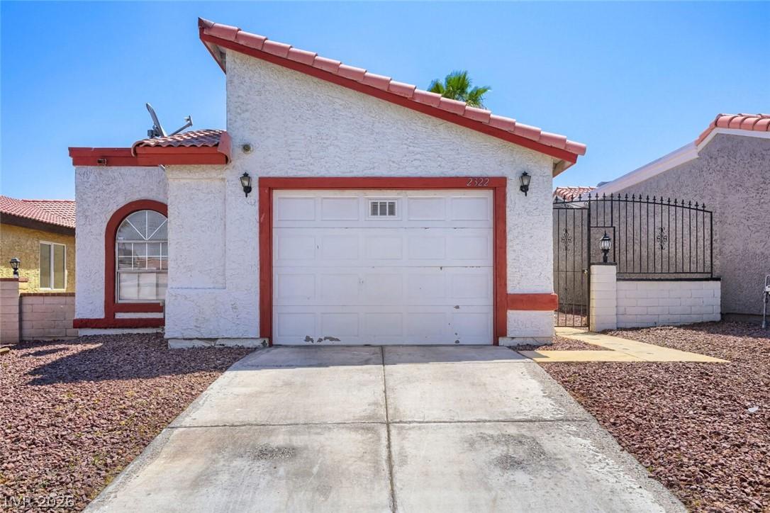 Image 3: A well-maintained facade with a garage and a decor