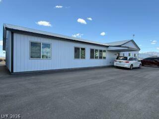 Image 1: A well-maintained facade with ample parking awaits