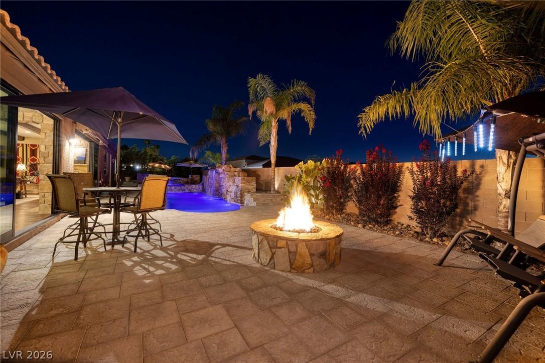Image 4: Expansive tiled patio with firepit