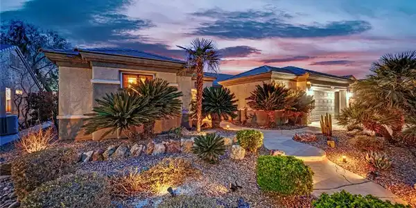 Image 2: Desert landscaping and a paved walkway lead toward