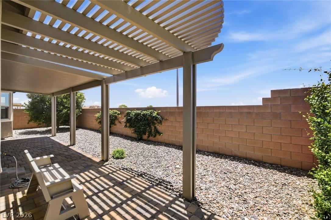 Image 2: Enjoy outdoor living on this shaded patio, featuri