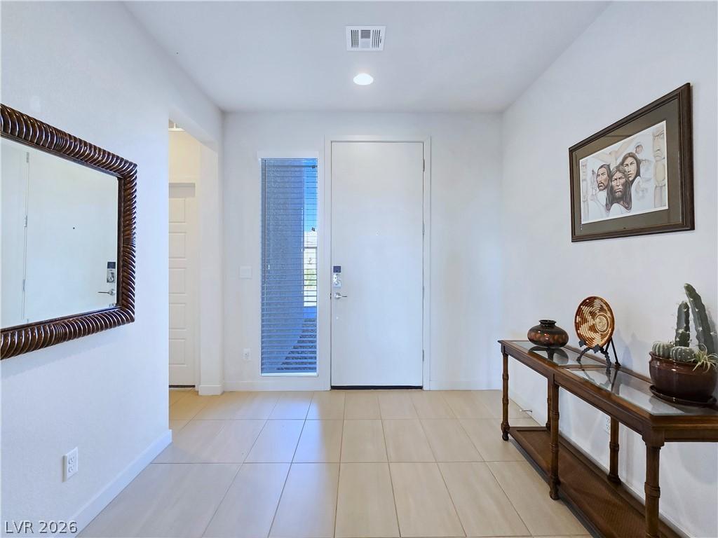 Image 3: A welcoming entryway with a contemporary front doo
