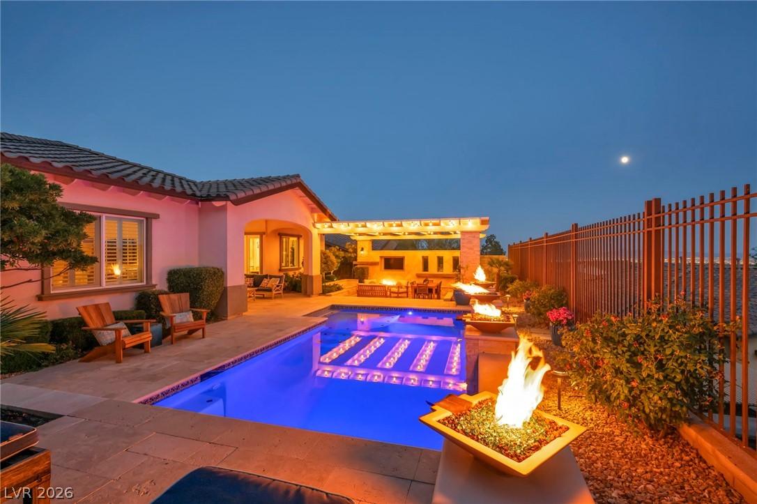 Image 2: An inviting backyard oasis offers a sparkling pool