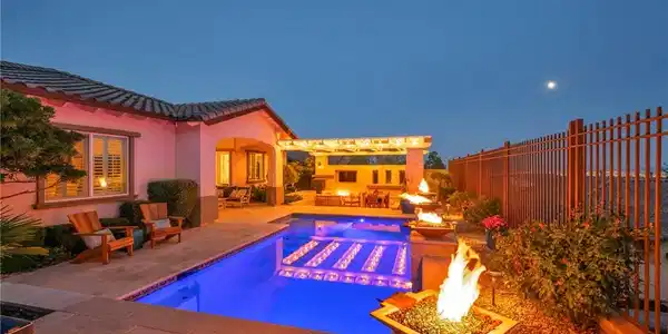 Image 2: An inviting backyard oasis offers a sparkling pool