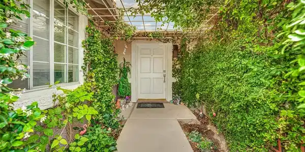 Image 4: Doorway to property past privacy gate
