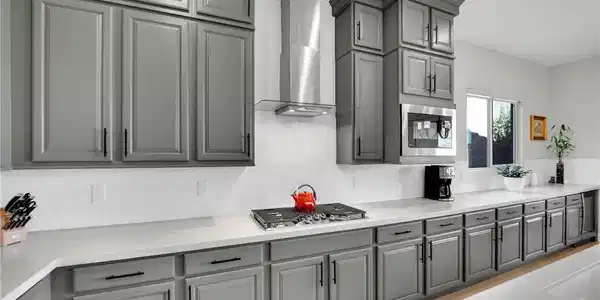 Image 2: Gleaming stone countertops and matching cabinetry