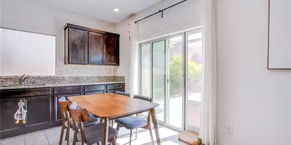 Image 4: Dining room with light tile patterned floors and r