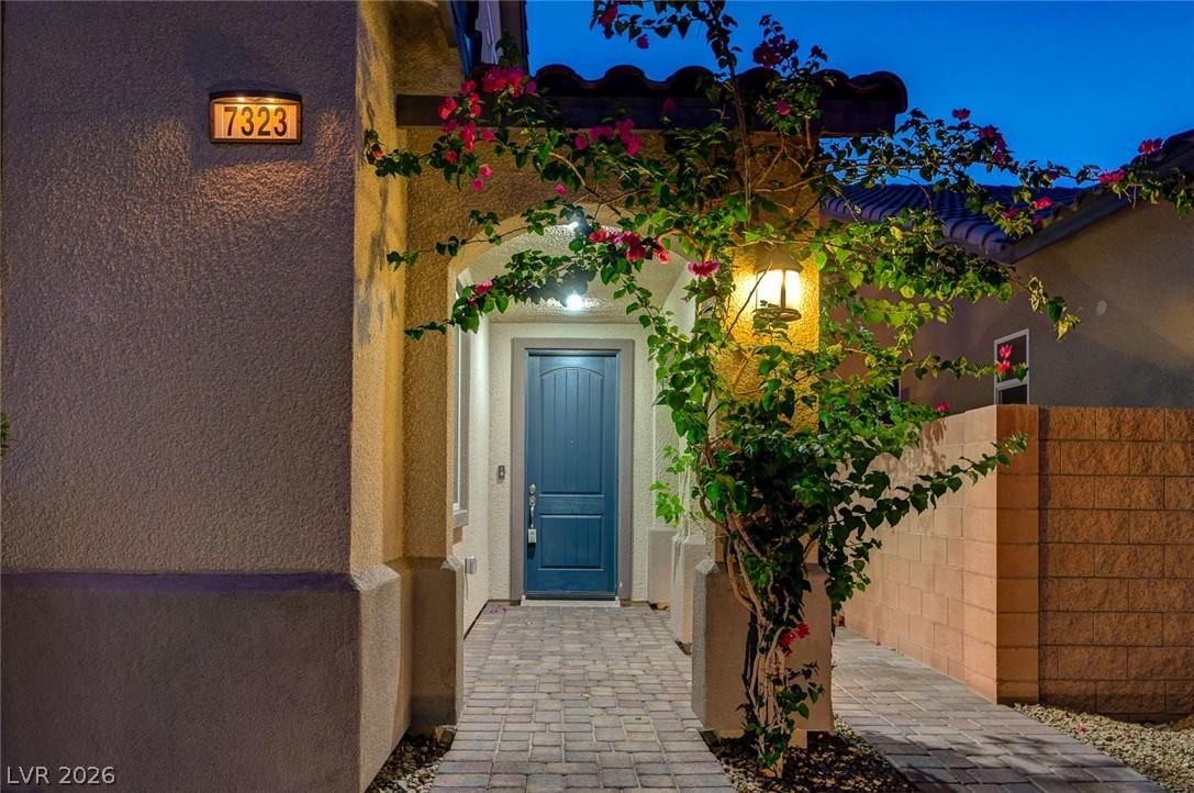 Image 4: A charming entrance with climbing flora and a welc