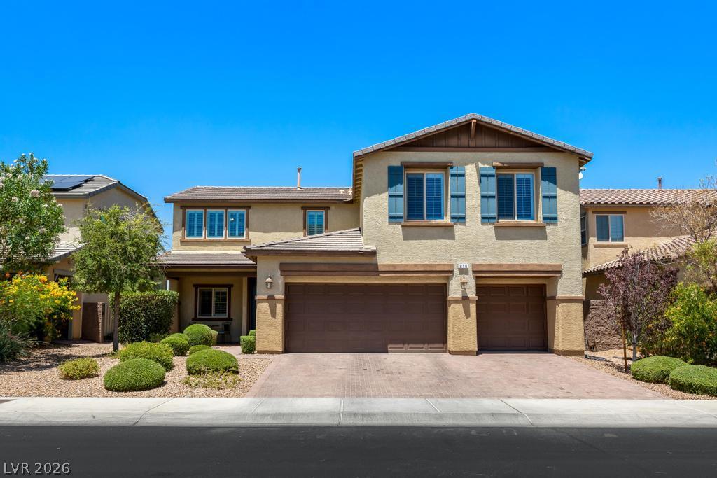 Image 1: A welcoming facade features a paved driveway and a